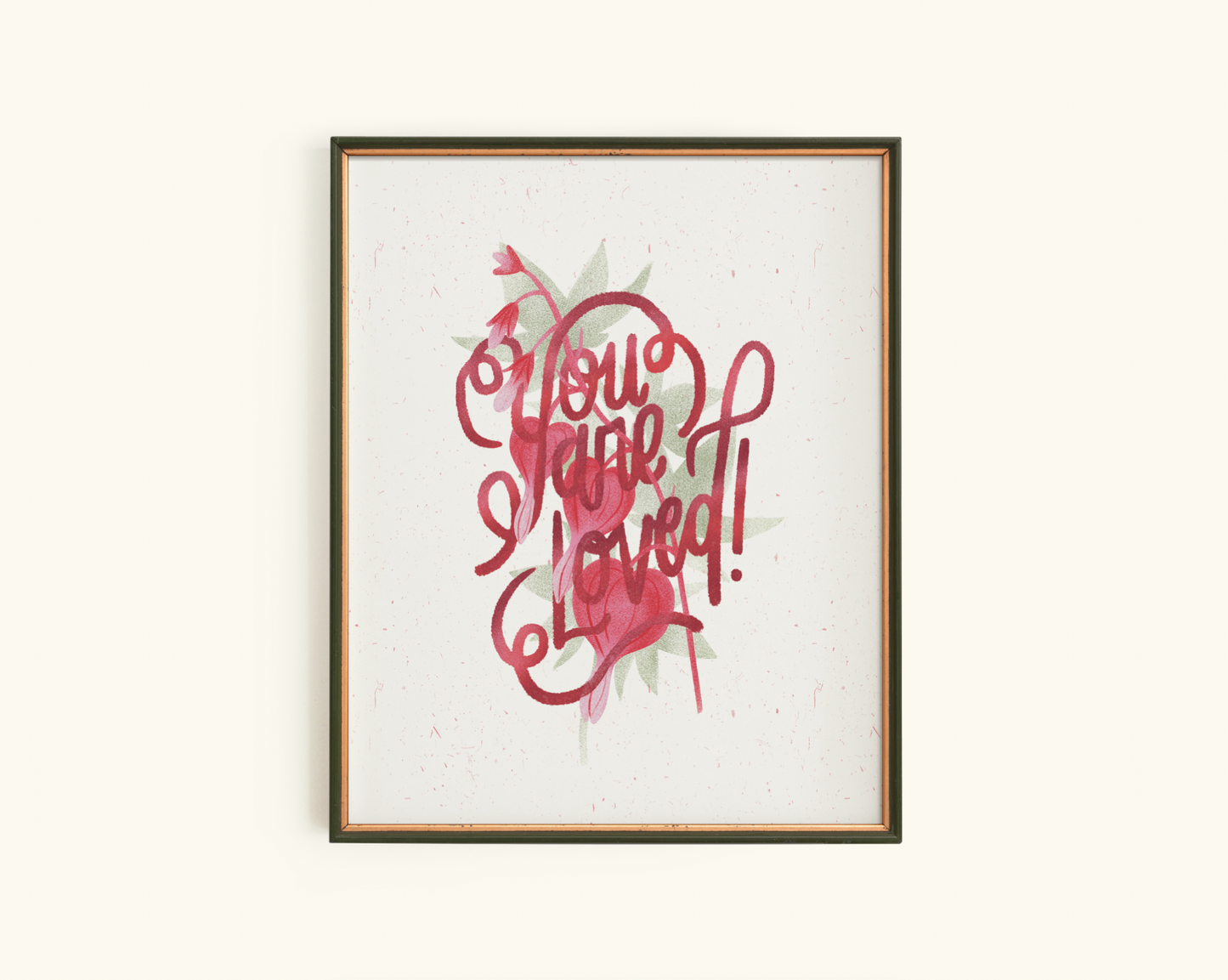 Framed artwork with red text stating "you are Loved" and bleeding heart design on a creamy white background
